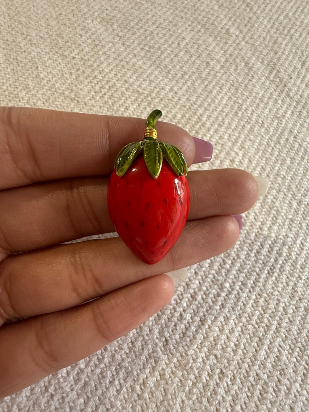 Vintage high-gloss red enamel strawberry brooch.